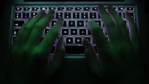 Illustration file picture shows a man typing on a computer keyboard in Warsaw