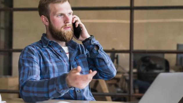 serious bearded man talking cell Економічні новини - головні новини України та світу